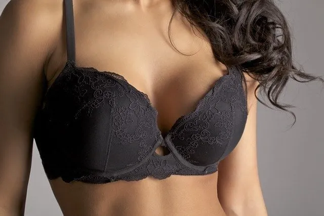 a woman in a black bra posing for a picture