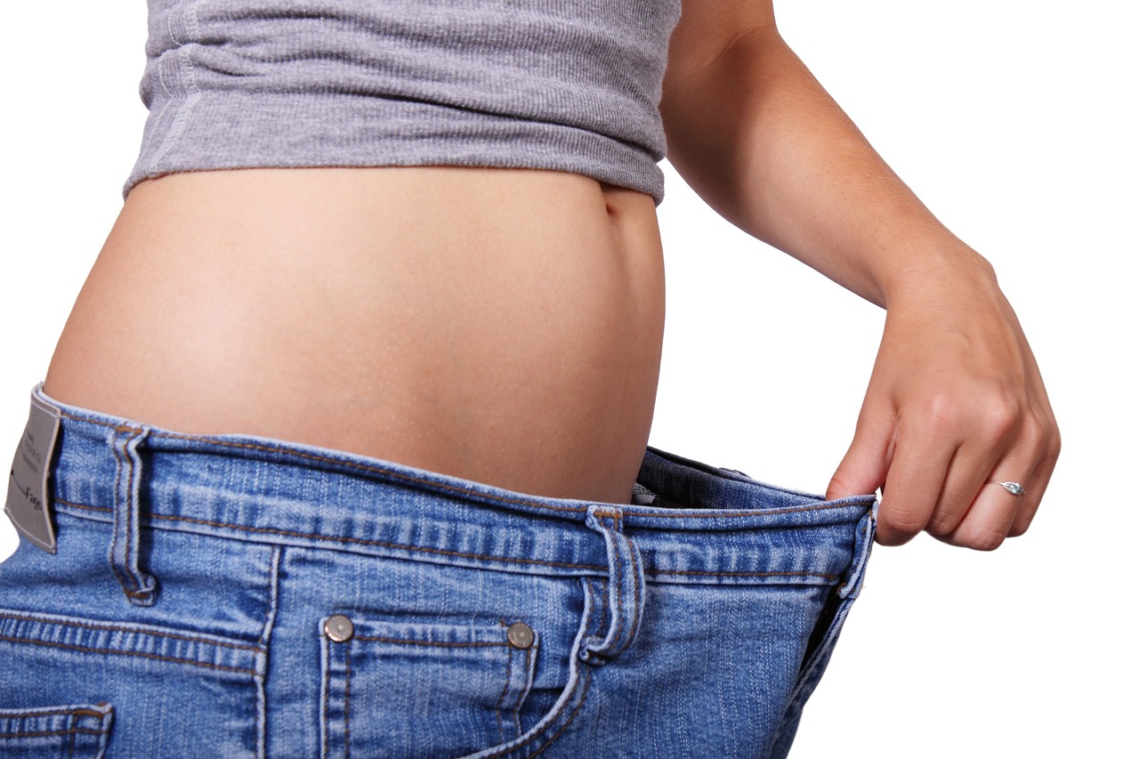 a woman's stomach is shown in a pair of jeans