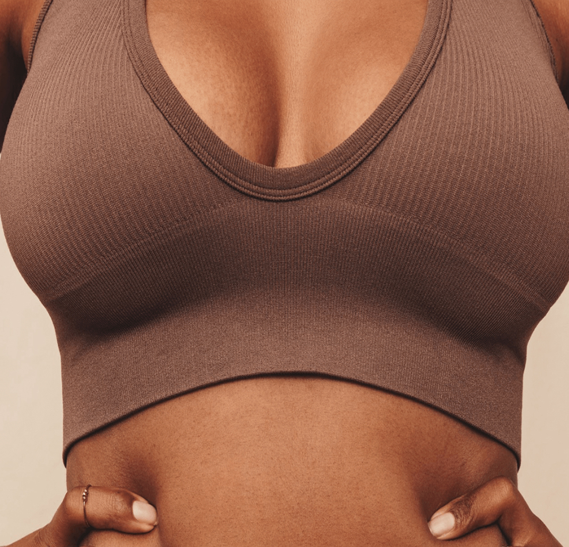 a woman in a sports bra holding her stomach