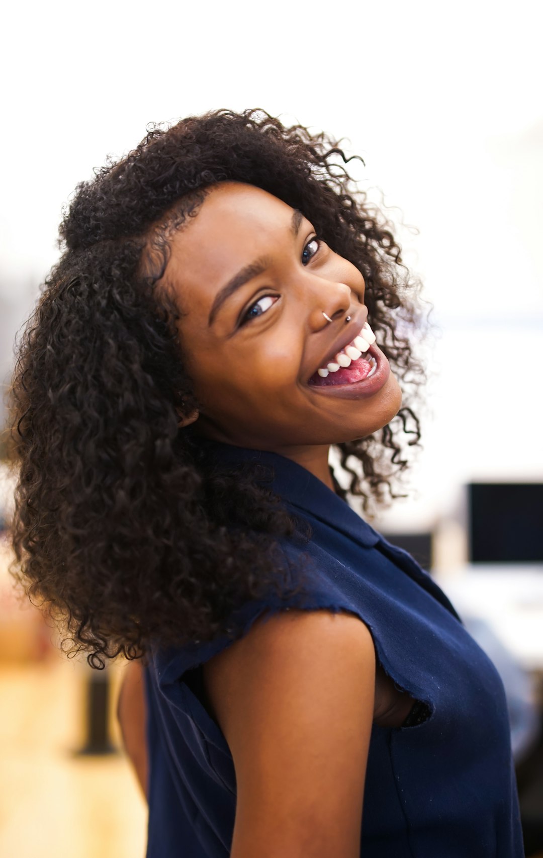 woman looking back while smiling after RF microneedling